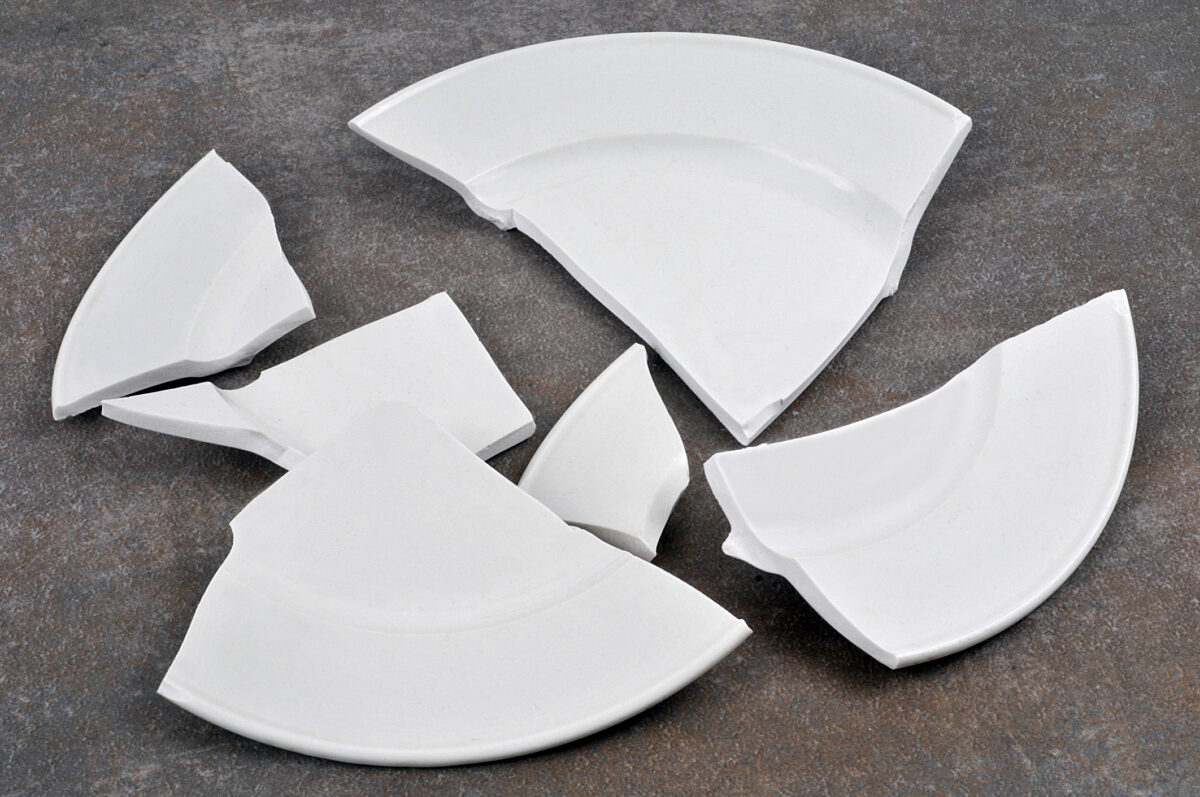 concept of clumsiness and household scene with broken dishes