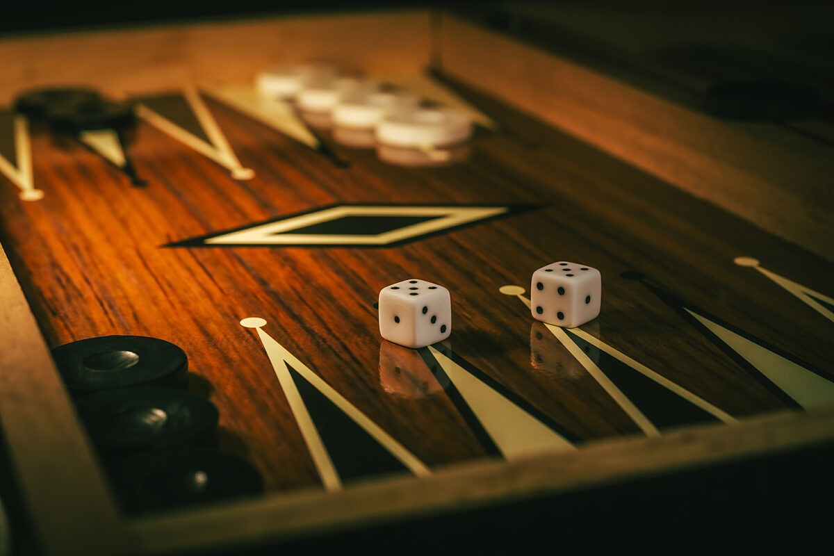 Backgammon game with dices on wooden board.